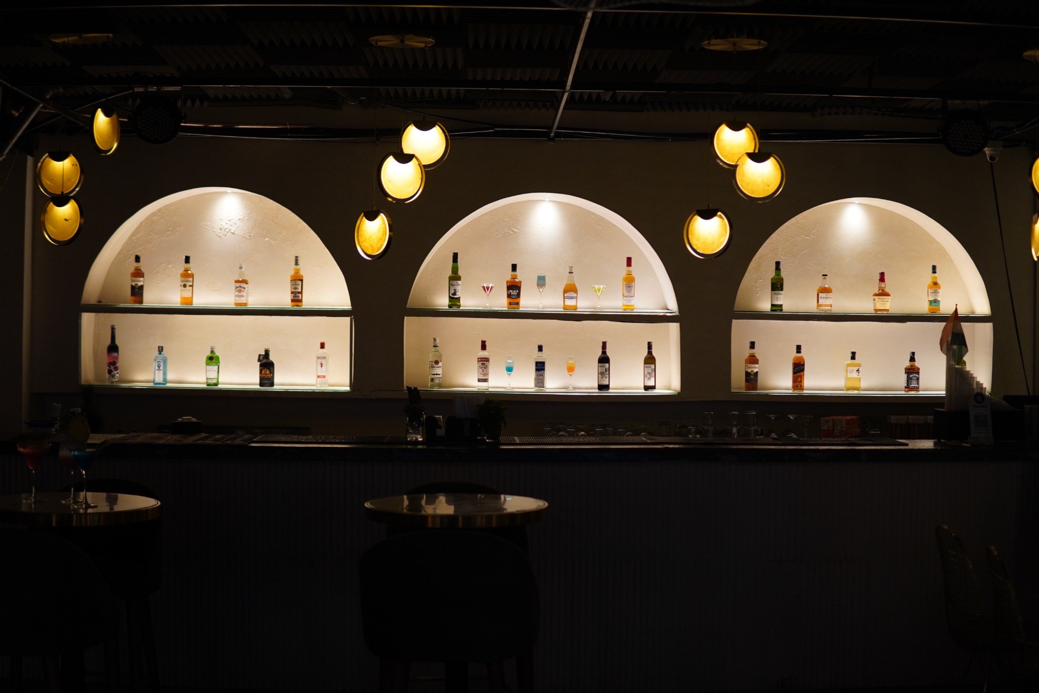 The illuminated bar with backlit arched shelving