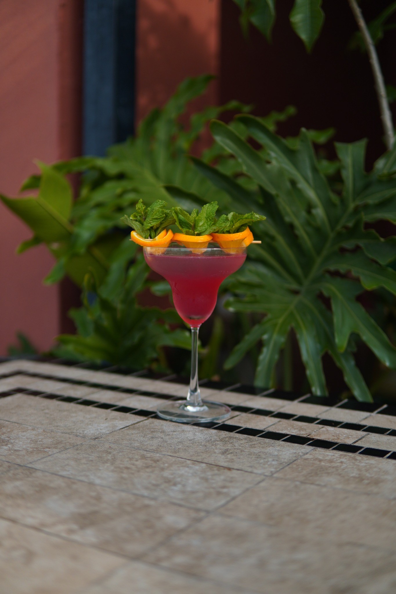 A red signature cocktail on the rooftop