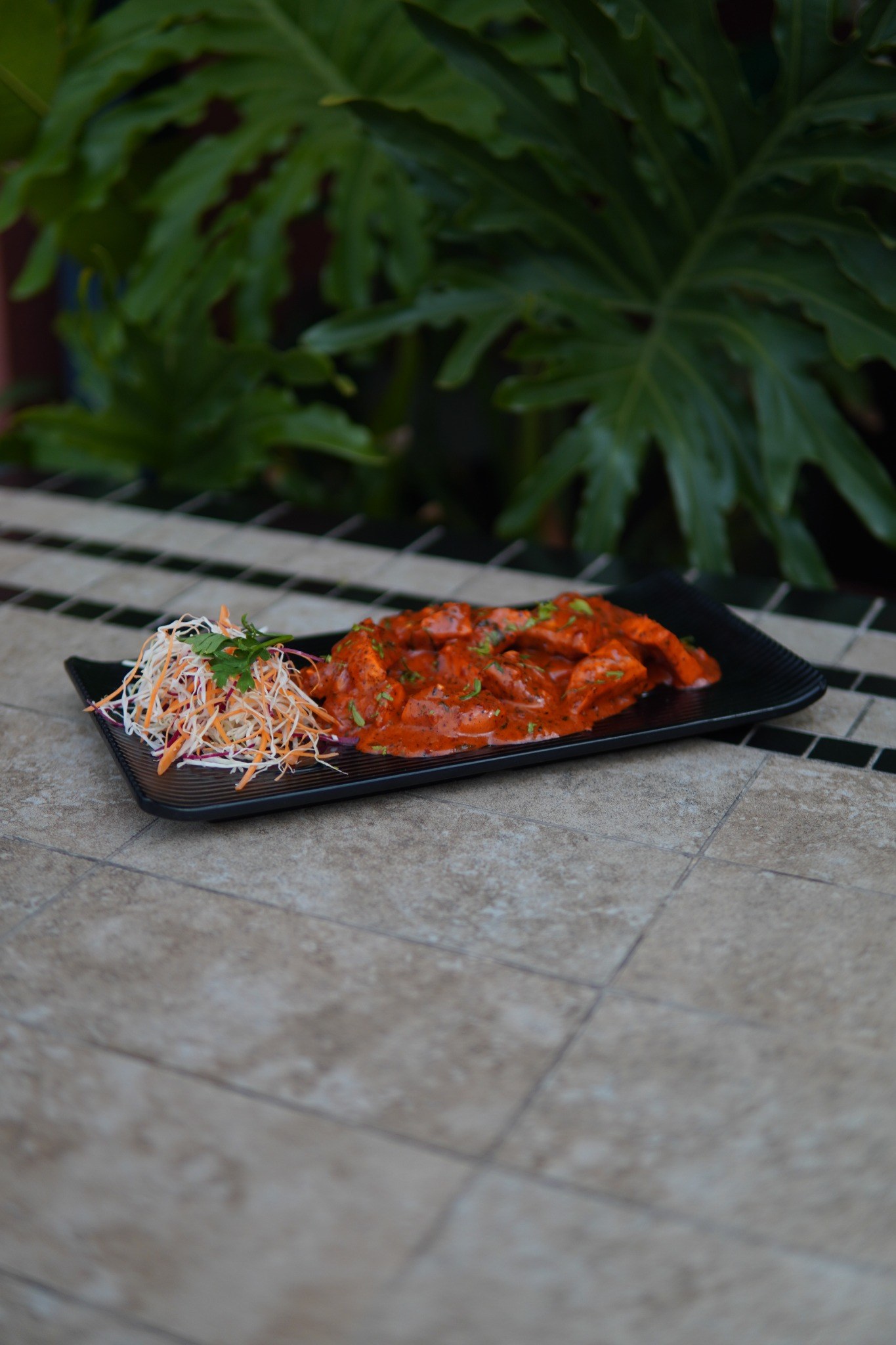 A signature plate served on a black dish