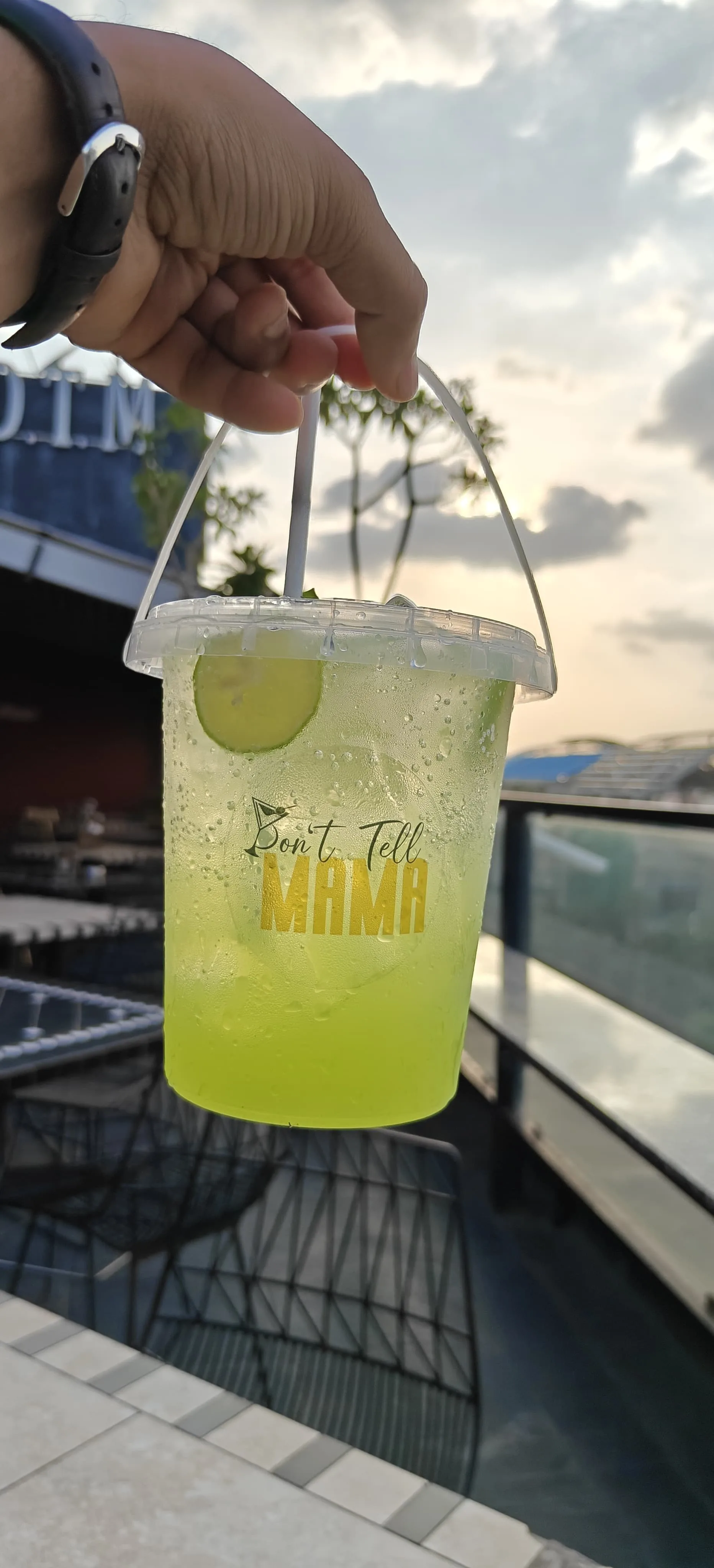 The Green Island LIIT — the house long island, served green over ice with lime in the Don't Tell Mama cup